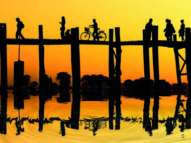 Silhouette Of People Traveling Across The U Bein Bridge In The Evening, Taungthaman, Burma