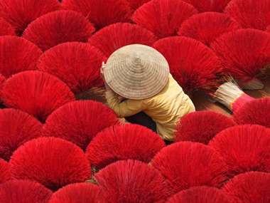 Vietnam Women Arranging Incense Sticks Photo